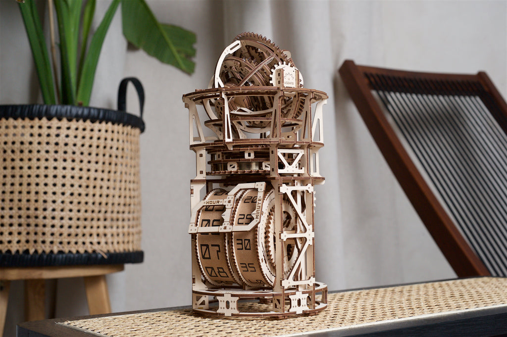 Wooden Tourbillon Table Clock on a sideboard next to a basket